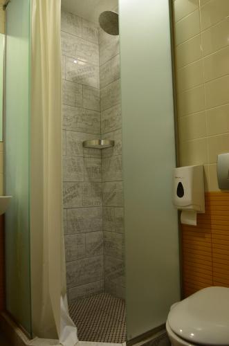 a shower in a bathroom with a toilet at Music Hostel in Poltava