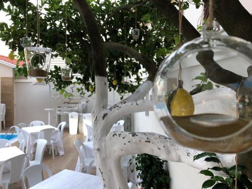 a glass bowl with a pear hanging from a tree at Hotel Smeraldo in Qualiano