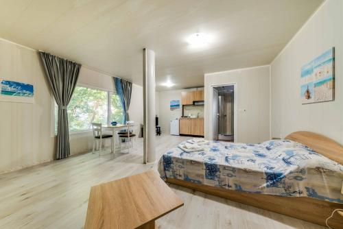 a bedroom with a bed and a table in it at Black Sea Pearl in Varna City