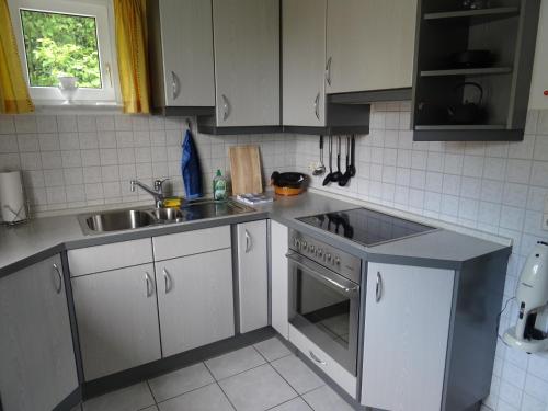 a kitchen with a sink and a stove at Ferienwohnung Seeblick in Überlingen