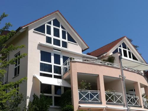 een appartementencomplex met grote ramen en een dak bij Ferienwohnung Seeblick in Überlingen