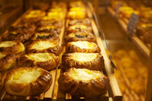 a bunch of pastries in a display case in a bakery at Hotel Agora Osaka Moriguchi in Osaka