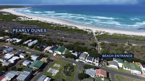arial view of a beach with houses and the ocean at Pearly Dunes in Pearly Beach
