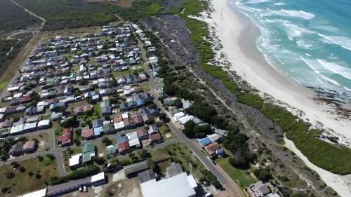 an aerial view of a beach with houses at Pearly Gate in Pearly Beach