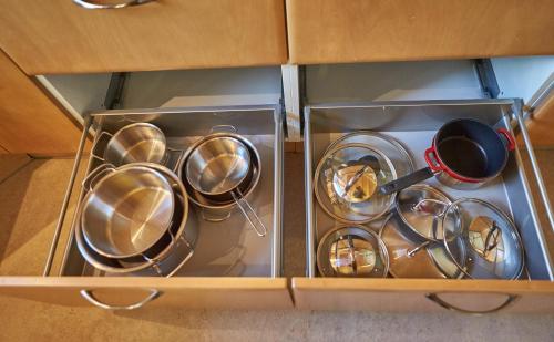 a bunch of pots and pans in a drawer at Chalet Birkenhof in Saalbach Hinterglemm