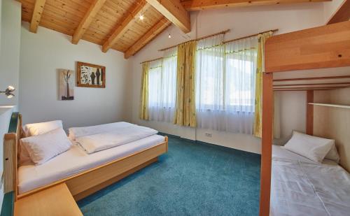 a bedroom with two bunk beds and a window at Chalet Birkenhof in Saalbach Hinterglemm