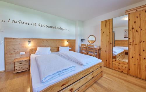 a bedroom with a large bed and a mirror at Chalet Birkenhof in Saalbach Hinterglemm