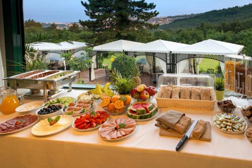 a table with a bunch of food on it at RAYA Garden - Park Hotel & Winery in Veliko Tŭrnovo