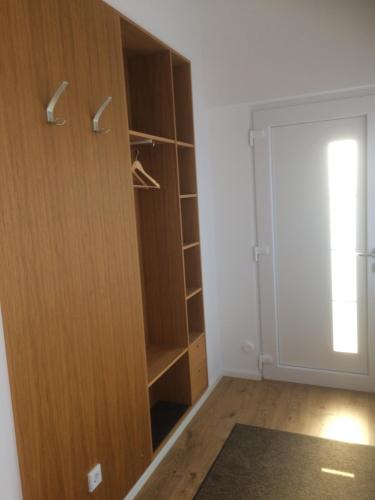 a closet with a wooden cabinet and a door at Eisenach - Apartments in Eisenach