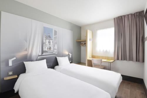 Voodi või voodid majutusasutuse B&B HOTEL Bourges 2 toas