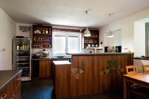 a kitchen with a wooden bar with a window at Penzion Amálka in Třeboň