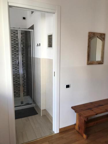 a bathroom with a walk in shower next to a mirror at Beija-Flor b&b in Verano Brianza