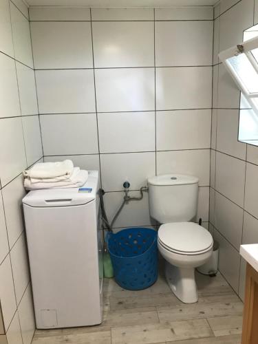 a small bathroom with a toilet and a trash can at A Casa do Avô Coelho in Santo Antão