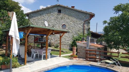 a house with a swimming pool in front of a building at Casa Elisa in Bibbiena