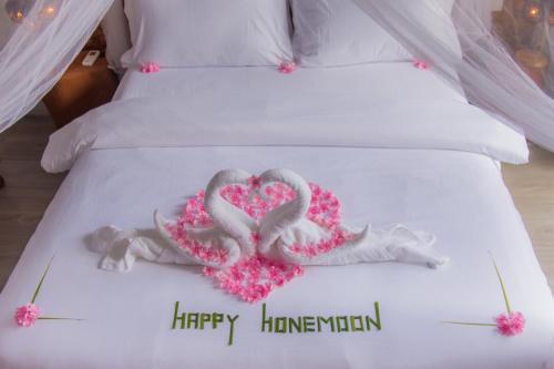 a bed with two swans made to look like hearts at Sandy Heaven Maldives in Gulhi