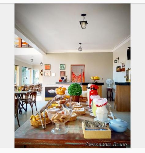 a kitchen with a table with food on it at Hotel Pousada Riacho da Areia in Águas de Lindóia