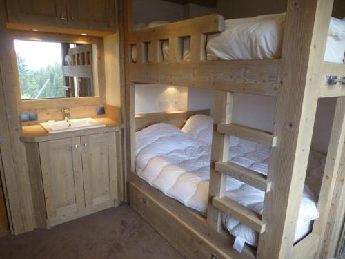 a bedroom with two bunk beds and a sink at Nogentil in Saint-Bon-Tarentaise