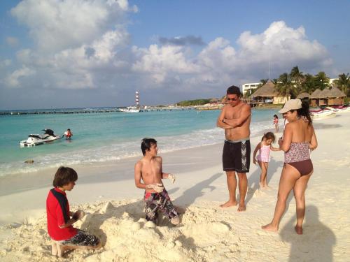 a group of people standing on a beach at BSEA Cancun Plaza Hotel in Cancún