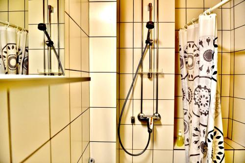 
a bathroom with a shower curtain hanging from the wall at Hostel Diana Park in Helsinki
