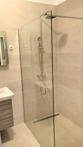 a shower with a glass door in a bathroom at Villa Sky with stunning view in Selca