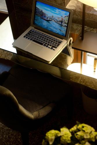 a laptop computer sitting on top of a desk at Residence La Fenice in Venice