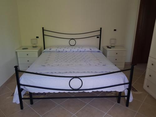 ein Bett in einem Schlafzimmer mit zwei Kommoden und einer Tagesdecke in der Unterkunft Il paradiso d'Oriente! in Tagliacozzo