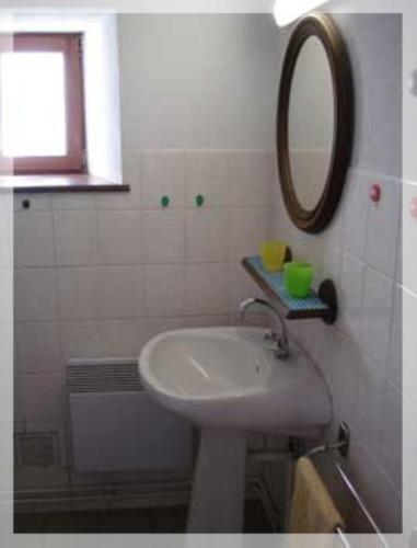 a bathroom with a sink and a mirror at Gîte Les Hirondelles in Plombières-les-Bains