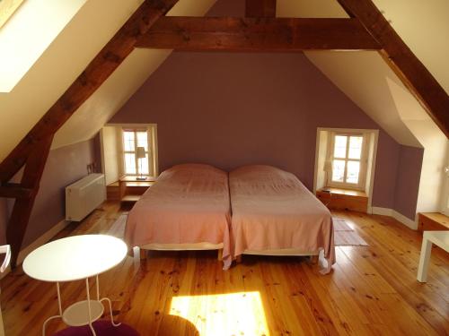アロマンシュ・レ・バンにあるVilla Madeleineのベッドルーム1室(屋根裏部屋に大型ベッド1台付)