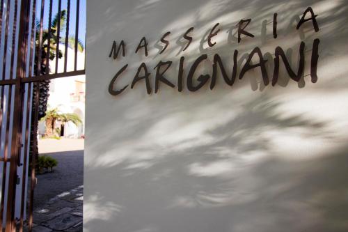 a sign for a restaurant on the side of a building at Masseria Carignani in Tuglie
