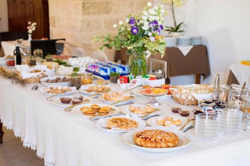 a long table with plates of food on it at Masseria Carignani in Tuglie