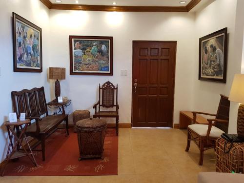 a waiting room with chairs and a door at Stay Amare Pacific Grand Magnolia in Mactan
