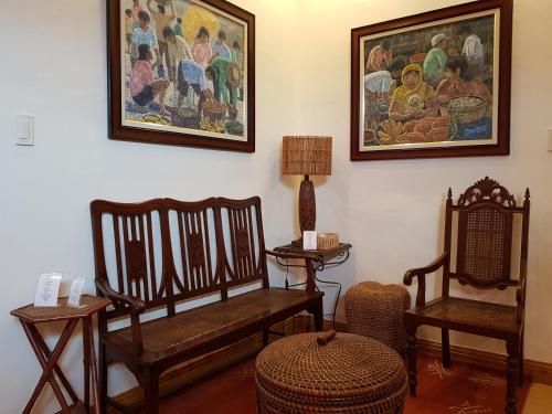 a living room with two chairs and a painting on the wall at Stay Amare Pacific Grand Magnolia in Mactan