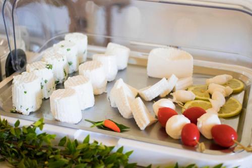 a tray filled with cheese and other food items at Masseria Carignani in Tuglie