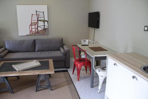 a living room with a couch and a table at Captain Yiannis in Vathi, Ithaka