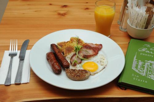 a plate of breakfast food with eggs sausage and toast at Lodge at The Old Barracks in Athenry