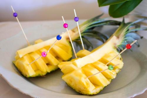 two pineapple skewers on a plate with tooth picks at Masseria Carignani in Tuglie