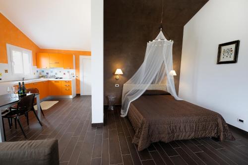 a bedroom with a bed with a mosquito net at Poggio dei Gorleri in Diano Marina