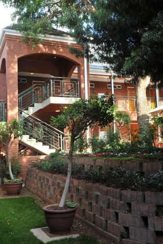 a brick building with a staircase in front of it at Premier Hotel Falstaff in Johannesburg