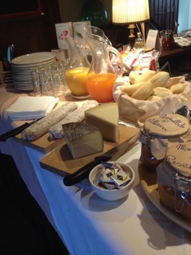 a table with cheese and other foods on a table at Il Peschio in Pescocostanzo