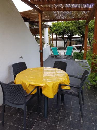 a yellow table and chairs on a patio at Stromboli Vacanze in Stromboli