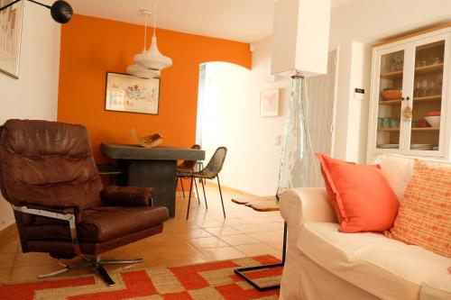 a living room with a couch and a chair at Yellow House - Checkinhome in Boliqueime