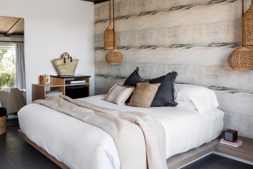 a bedroom with a white bed with pillows at AWOL Hotel Provincetown in Provincetown
