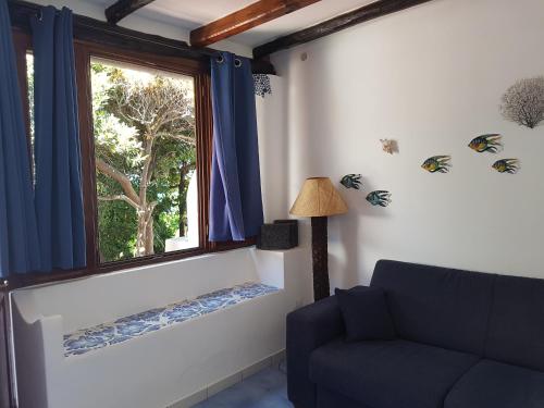a living room with a window and a couch at Stromboli Vacanze in Stromboli