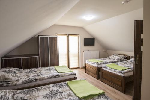 Voodi või voodid majutusasutuse Jurajskie Pokoje Pod Lasem toas