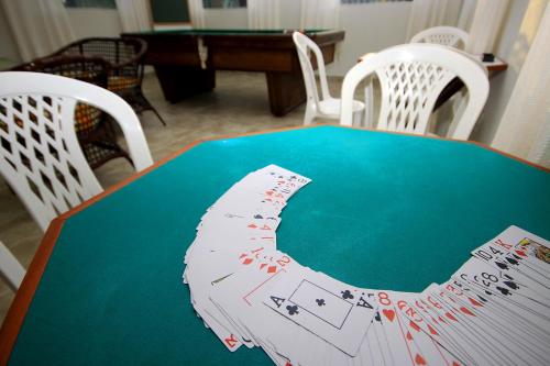 a table with poker cards on top of it at Igarakuê Flat in Japaratinga