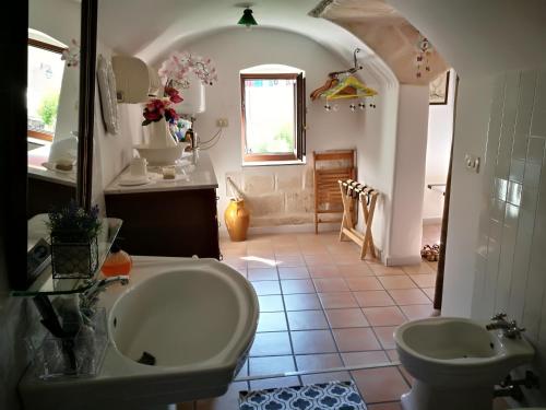 a bathroom with a sink and a toilet at Dimora nel cuore del Centro Storico di Monopoli in Monopoli