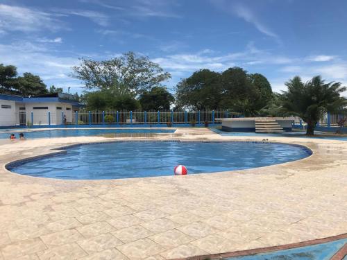 a swimming pool with a red ball in the middle at Hotel campestre la Maria in Villavicencio