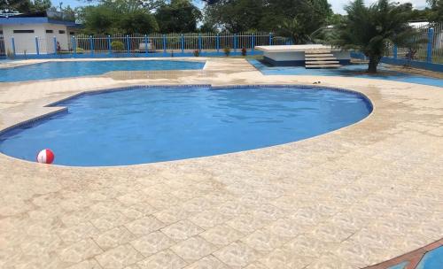 a large pool with blue water in the middle at Hotel campestre la Maria in Villavicencio