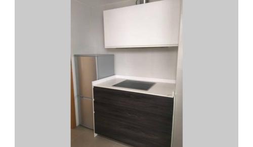 a kitchen with a sink and a white cabinet at Petit con piscina in Pontevedra