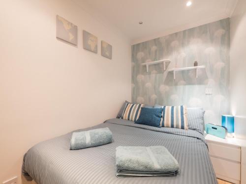 a bedroom with a bed with two pillows on it at CitiStay Central in Leeds